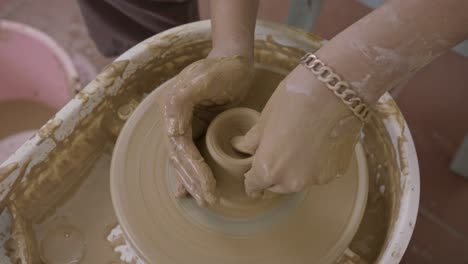 Clay-worker-uses-experience-to-skilfully-throw-a-clay-pot-on-spinning-turntable-CLOSE-UP