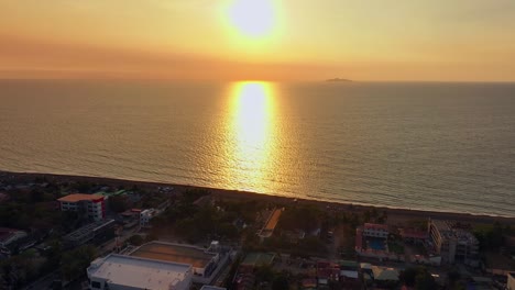 Toma-Cinematográfica-De-Un-Dron-Que-Muestra-Una-Ciudad-Costera-Asiática-En-El-Océano-Durante-La-Hora-Dorada.