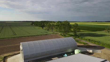 Gewölbte-Halle-Lagerung-Lager-Produktion-Bauernhof-Anlage-Im-Feld-Sonnig