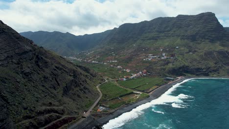 Aerial-View-Over-the-City-of-Hermigua,-Surrounded-by-Tall-Mountain-Peaks,-La-Gomera-Island,-Spain