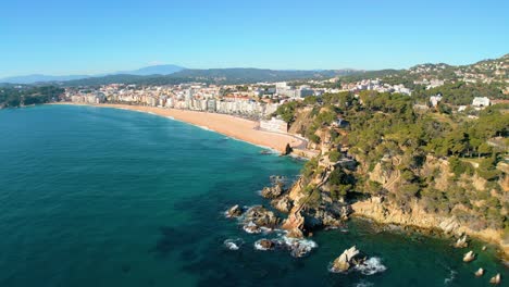 Aerial-views-of-the-beach-of-Lloret-De-Mar,-Skyline-of-the-buildings,-front-line-young-tourism-Europe,-Mediterranean-square