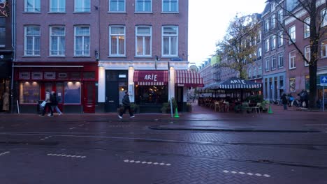 Pedestrians-On-Street-With-Tramway-In-Amsterdam,-Netherlands