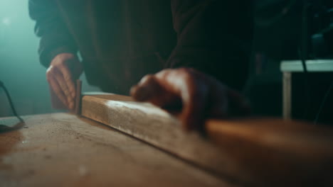 Sanding-down-the-surface-of-a-wooden-plank-to-get-it-ready-for-painting