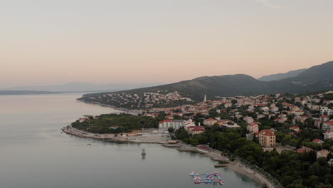 Panoramic-view-of-a-coastal-town-in-Croatia,-Adriatic-coastline,-rocky-beaches,-sunrise,-seaside-homes,-balkan-summer-vacation,-holiday-destination,-mediterranean-landscape,-pristine-waters,-tourism