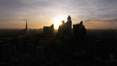 Slow-wide-dolly-back-aerial-shot-of-the-city-of-London-skyscrapers-silhouette