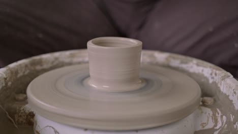 Creative-potter-dexterity-in-shaping-wet-claypot-on-fast-rotating-wheel-CLOSE-UP