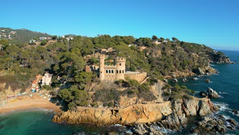 aerial-views-of-the-Lloret-De-Mar-castle-on-the-beach-of-Sa-Caleta,-Costa-Brava-of-Gerona,-in-Spain-60-km-from-Barcelona