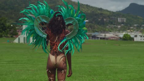 Dressed-in-her-vibrant-carnival-attire,-a-young-girl-adds-to-the-colorful-spectacle-of-Trinidad's-tropical-Carnival-festivities