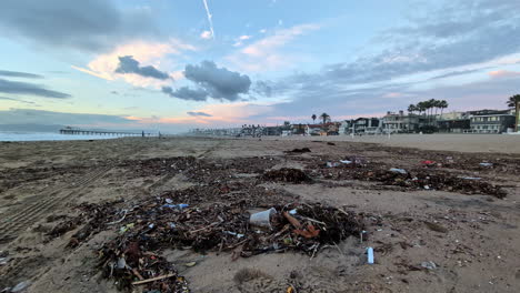 Waste-and-trash-on-the-dirty-beaches-of-Los-Angeles,-sunset-in-California,-USA