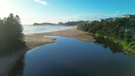 Drone-aerial-Terrigal-sandy-beach-bend-lagoon-lake-water-ocean-waves-suburbs-main-town-Avoca-Central-Coast-travel-tourism-Australia