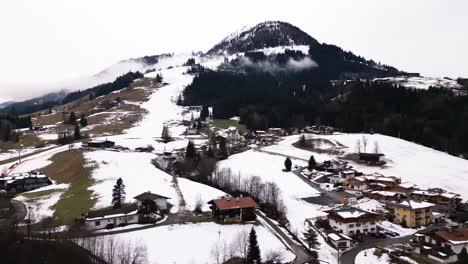 Snowy-landscape-and-Kirchberg-township,-aerial-drone-view