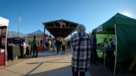 POV---Walking-thru-the-pavilions-of-farmer's-market-that-hosts-Southern-Arizona-farmers,-ranchers-and-artisan-food-purveyors