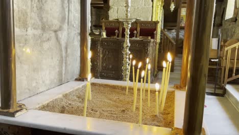 Static-shot-of-candles-burning-in-an-old-church