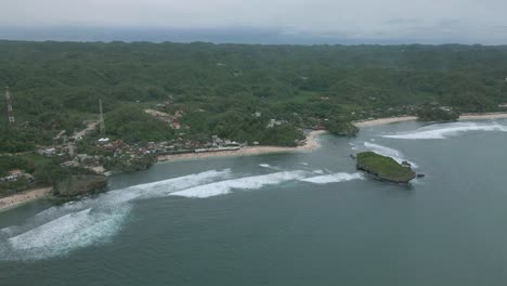Tropical-jungle-and-beach-on-Indonesia-coastline,-aerial-panoramic-view