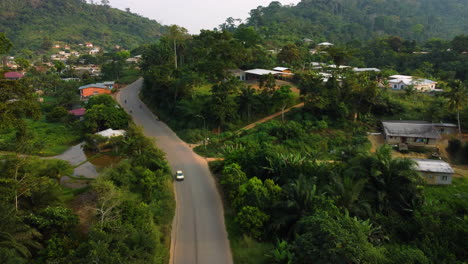 Aerial-view-rising-over-tropical-nature-and-houses-in-the-Ebolowa-town,-Cameroon