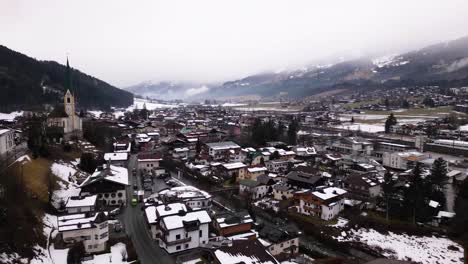 Beautiful-Kirchberg-township-on-misty-day,-aerial-hyper-lapse-view