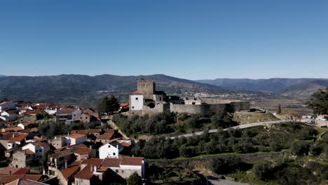 Belmonte-Castle-Amidst-Quaint-Village-Scenery,-Portugal---aerial