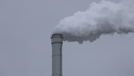 Grey-smoke-coming-out-from-a-chimney