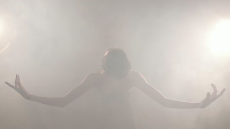 Cheerful-elegant-Japanese-girl-performing-ballet-in-the-smoke