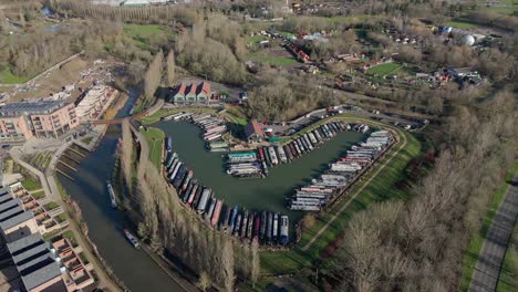 An-aerial-view-of-Campbell-Wharf-Marina-and-the-moored-barges-on-a-sunny-winter-morning-in-Milton-Keynes,-Buckinghamshire,-UK