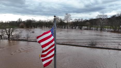 Bandera-Americana-Sobre-Agua-Turbia-Marrón-Del-Río-Inundado-En-El-Parque