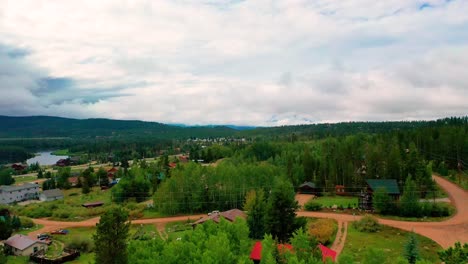 Aerial-Drone-Reveal-of-the-Town-of-Grand-Lake,-Colorado-with-Peaceful-Mountain-Vacation-Homes-Surrounded-by-Pine-Tree-Forests-on-Couldy-Summer-Day