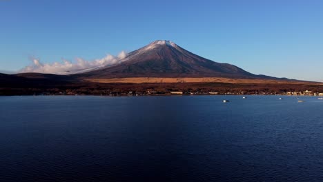 Majestic-Mount-Fuji-with-a-clear-blue-sky-reflected-in-the-calm-lake-waters-at-dusk