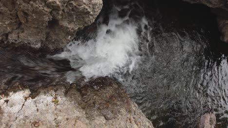 A-still-top-view-of-a-mini-waterfall-in-between-rocks