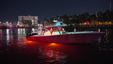 Night-Shot-Of-Riverwalk-Holiday-Lighted-Boat-Parade-Celebrating-Christmas-and-the-Holidays,-Tampa-Florida