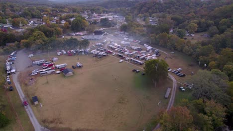 Aerial-establishing-shot-of-the-BBQ-championships-area-in-Lynchburg,-TN-with-a-lot-of-smoke