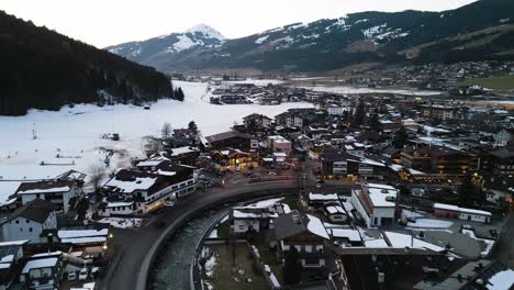 Snowy-winter-landscape-in-Alps-and-small-township-of-Kirchberg,-aerial-drone-view