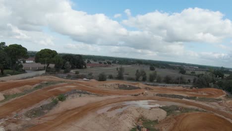 Aerial-forward-view-of-a-red-clay-motocross-track