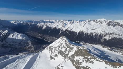 Aerial-view,-snow-mountain-peak-in-the-french-alps-on-a-sunny-day,-Chamonix-region