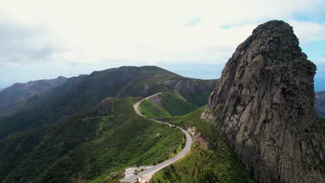 Aerial-View-of-the-Iconic-Roque-de-Agando-Surrounded-by-Lush-Vegetation,-La-Gomera-Island,-Spain