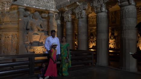 Tourists-clicking-photographs-in-front-of-the-Buddha-statue-at-Ajanta-Caves-26-Chaitya-Hall