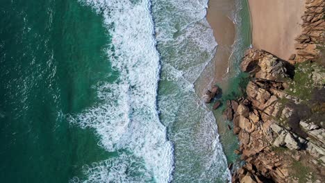 Olas-Turquesas-Vista-De-Arriba-Hacia-Abajo-Sobre-La-Playa-De-Cornualles-Con-Acantilados-Rocosos