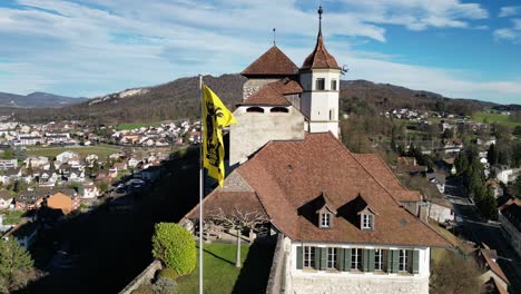 Aarburg-Aargau-Switzerland-flag-closeup-with-crest-in-the-wind-static-aerial