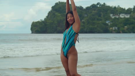 Along-the-pristine-shores-of-Las-Cuevas-beach,-a-young-girl-enjoys-the-blissful-tranquility-of-Trinidad's-tropical-paradise,-dressed-in-her-bikini-with-effortless-elegance