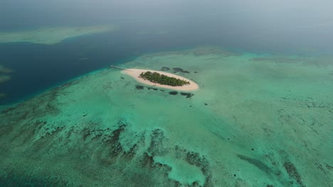 Drone-flight-over-private-island-surrounded-by-coral-reef-in-Fiji