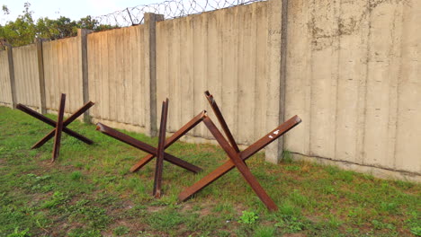 Czech-hedgehogs-and-a-long-barbed-wire-wall-in-Kyiv-Ukraine,-Dragon's-teeth-anti-tank-stoppers,-Russia-Ukraine-war,-famous-Wwii-obstacles,-4K-shot