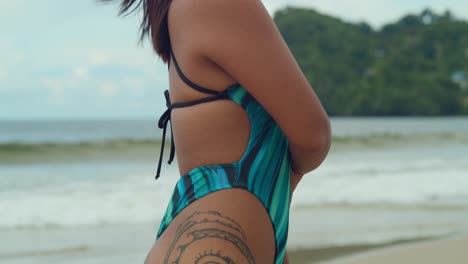 Against-the-backdrop-of-Las-Cuevas-beach's-serene-beauty,-a-young-girl-lounges-in-her-bikini,-soaking-up-the-essence-of-Trinidad's-tropical-allure