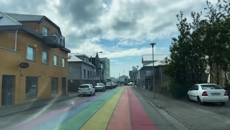 Driving-down-the-rainbow-street-in-Akranes-during-Queer-festival,-Iceland