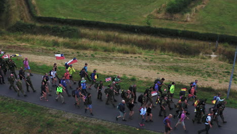 Long-line-of-walkers-during-the-Four-Days-Marches-Nijmegen,-Dutch,-aerial-tracking-shot