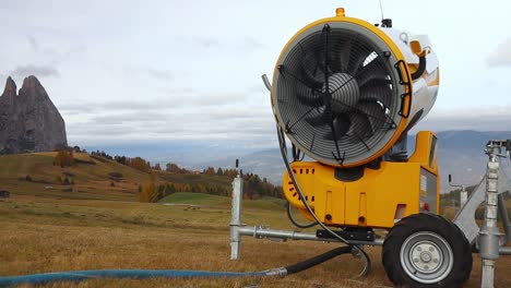 Snow-cannon-fan-spins-freely-in-the-wind-out-of-season-in-the-Alpine-mountains-in-Italy