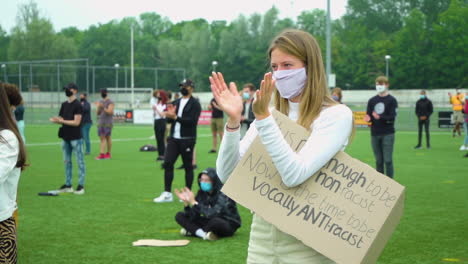 Slow-motion-of-blond-woman-applauding-during-peaceful-demonstration-for-Black-Lives-Matter-movement