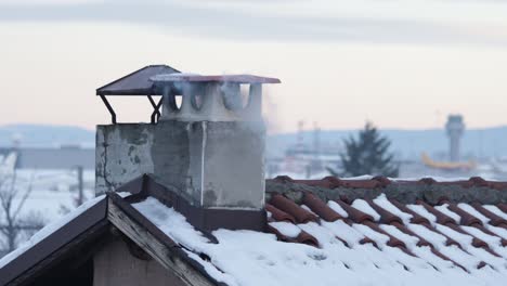 Residential-house-in-the-suburbs-during-cloudy-day-in-cold-winter,-polluting-the-air-with-thick-smoke