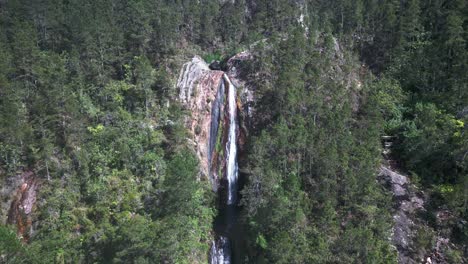 Person-diving-in-natural-pool-of-Salto-de-Aguas-Blancas-waterfall,-Constanza-in-Dominican-Republic