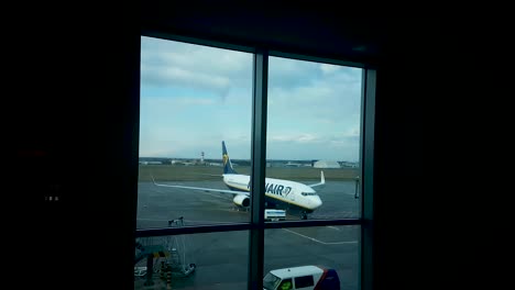 Ryanair-Airplane-on-Idle-Budapest-Airport,-Consequence-of-Corona-Virus-Spreading,-Gate-Window-View