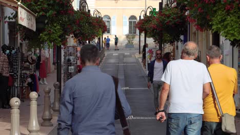 People-walk-leisurely-on-shopping-street-in-Antibes-Old-Town-in-summer