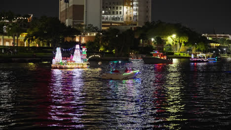 Christmas-lights-shimmer-and-reflect-off-waterway-canal-during-Christmas-parade-of-boats